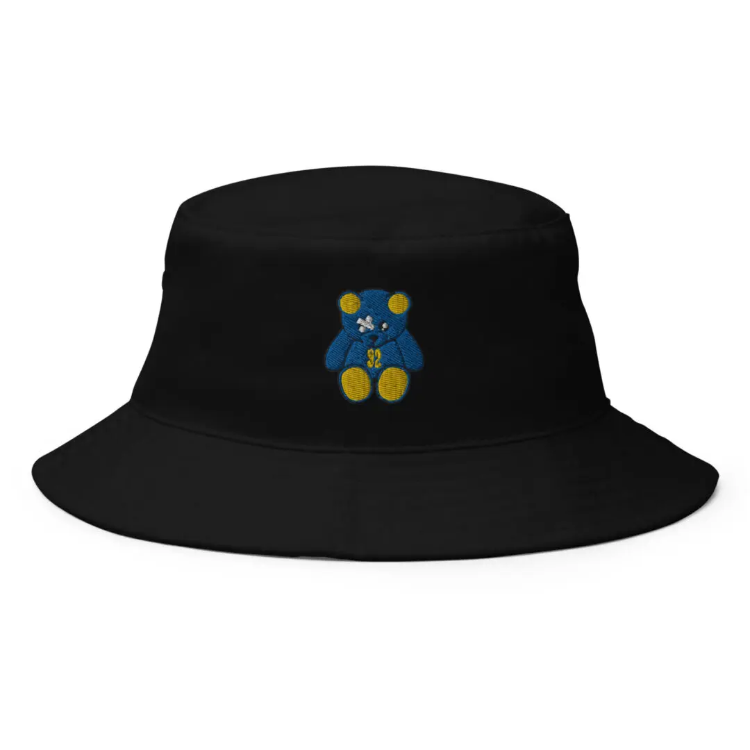 A black bucket hat with a blue and yellow teddy bear on it.