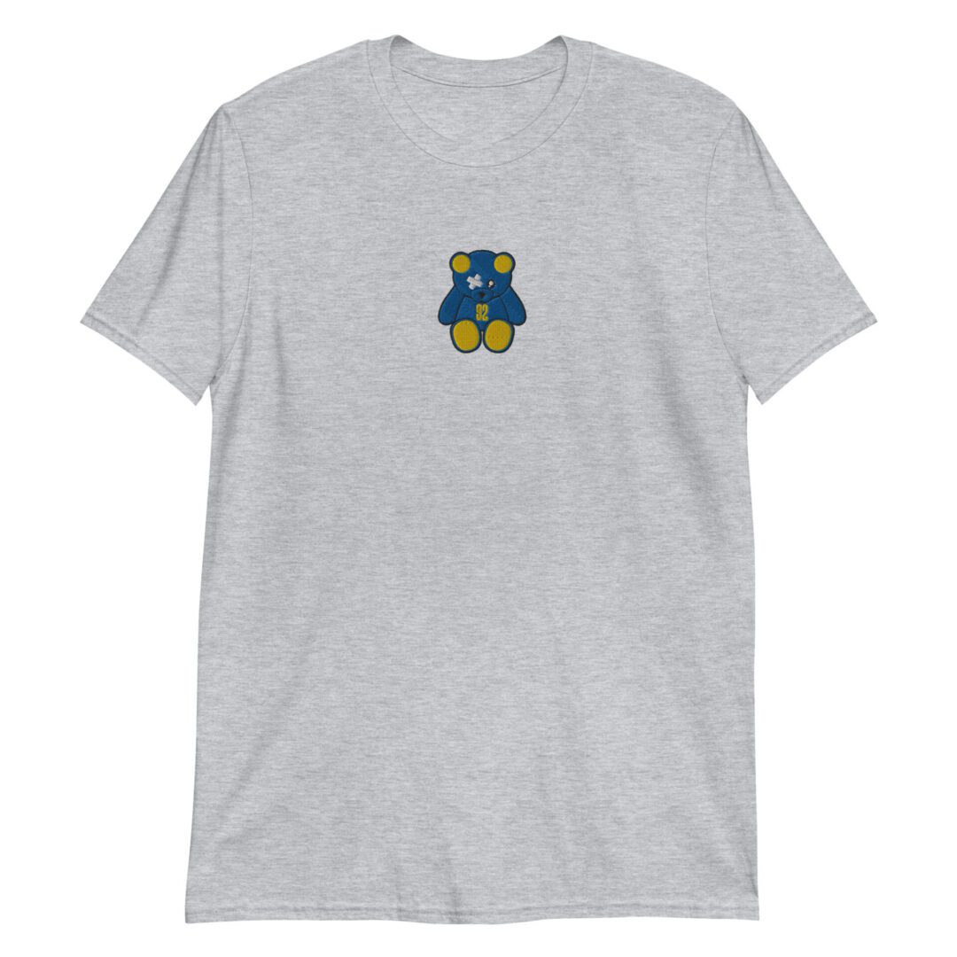 A gray t-shirt with a blue and yellow teddy bear on it.