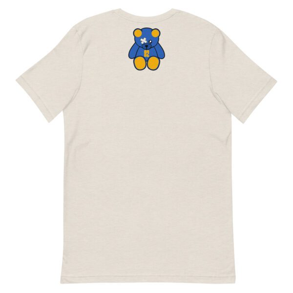 A white t-shirt with a blue and yellow bear on the back.