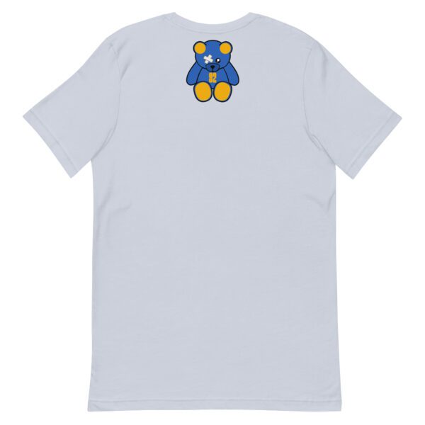 A white t-shirt with a blue and yellow bear on the back.